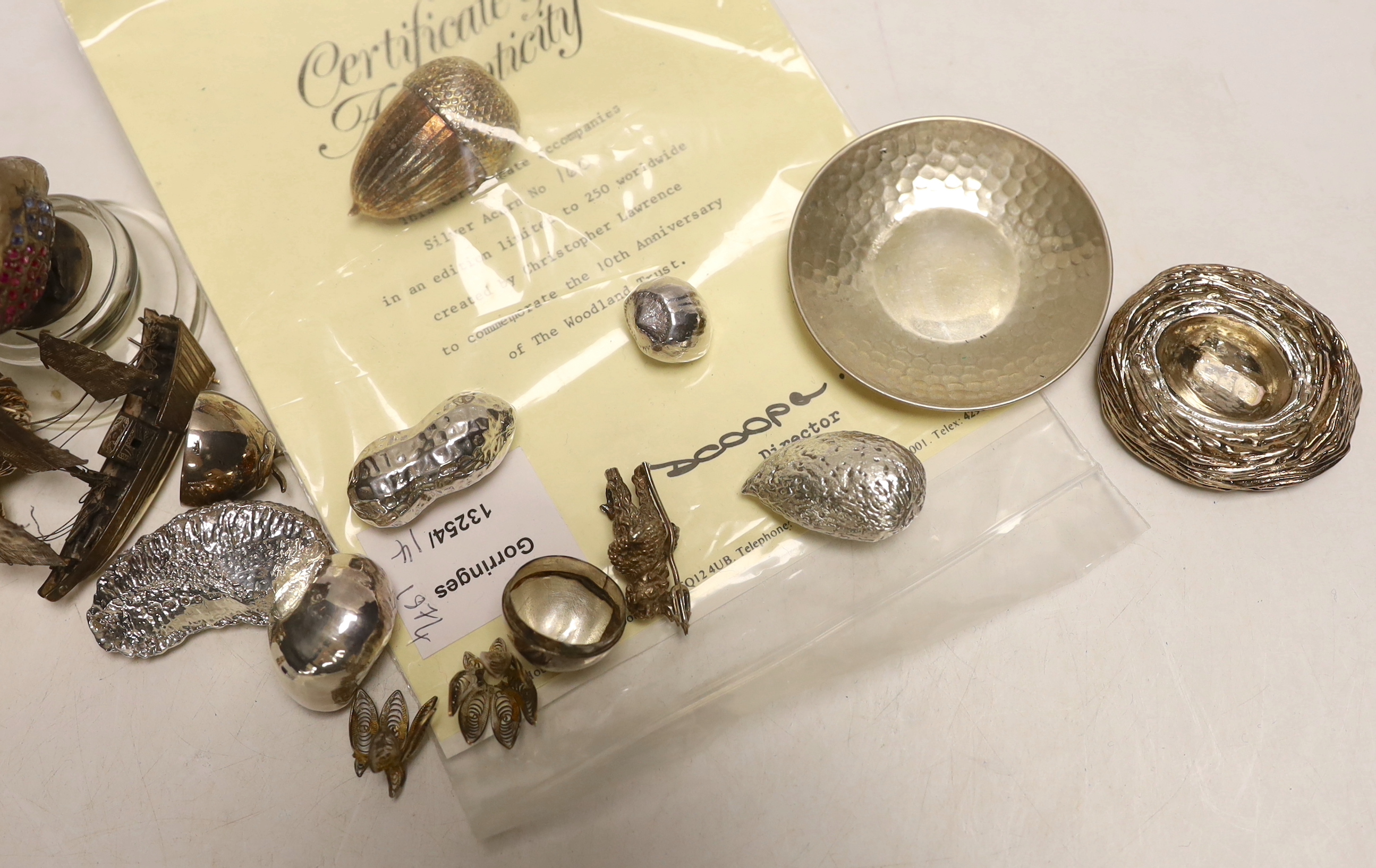 A group of modern novelty silver and white metal items including a limited edition surprise acorn by Christopher Nigel Lawrence, London, 1983, opening to reveal two squirrels, 43mm, with certificate, four novelty silver